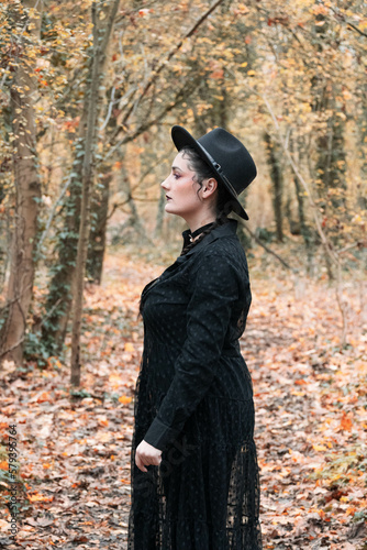 Woman dressed in black in the autumn forest