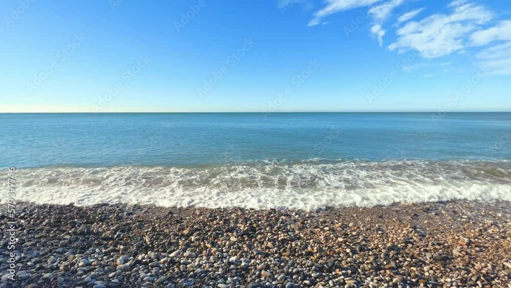 Sea waves on the Black Sea coast. Waves splash on the beach with pebbles in the rays of the sun. Sunset on the Black Sea. Panoramic view of the Black Sea. Kiseleva Rock, Russia, Agoi Sea waves on the Black Sea coast. Waves splash on the beach with pebbles in the rays of the sun. Sunset on the Black Sea. Panoramic view of the Black Sea. Kiseleva Rock, Russia, Agoi