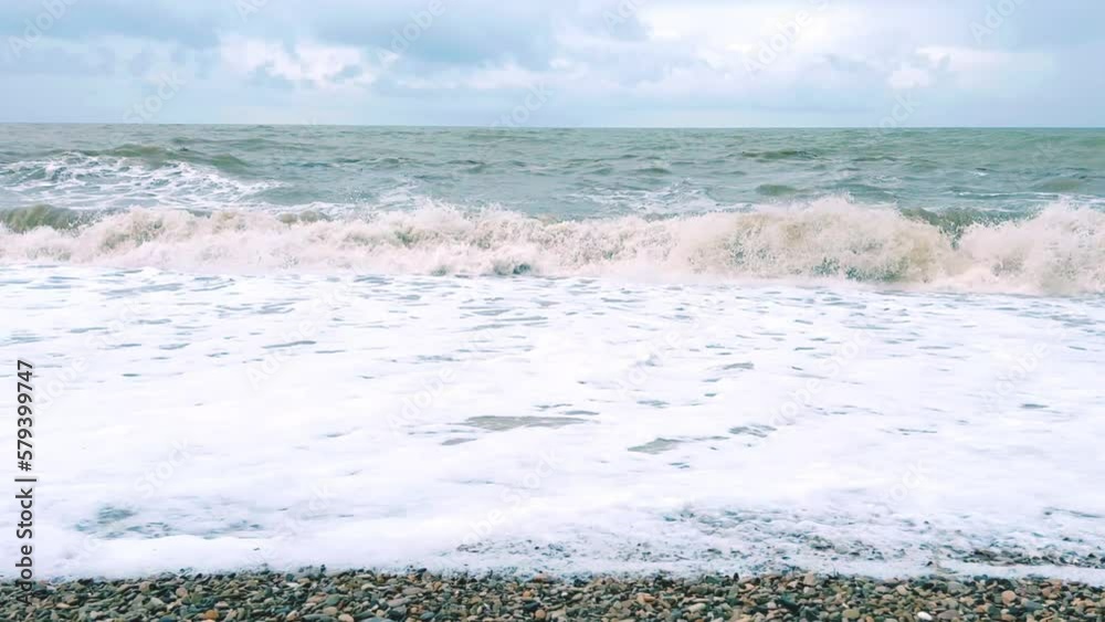 Powerful sea waves are crashing on the Black Sea coast. Waves splash on the beach with pebbles during a storm. Storm at sea. Panoramic view of the Black Sea. Russia. Sunset on the beach. 4K Powerful sea waves are crashing on the Black Sea coast. Waves splash on the beach with pebbles during a storm. Storm at sea. Panoramic view of the Black Sea. Russia. Sunset on the beach. 4K