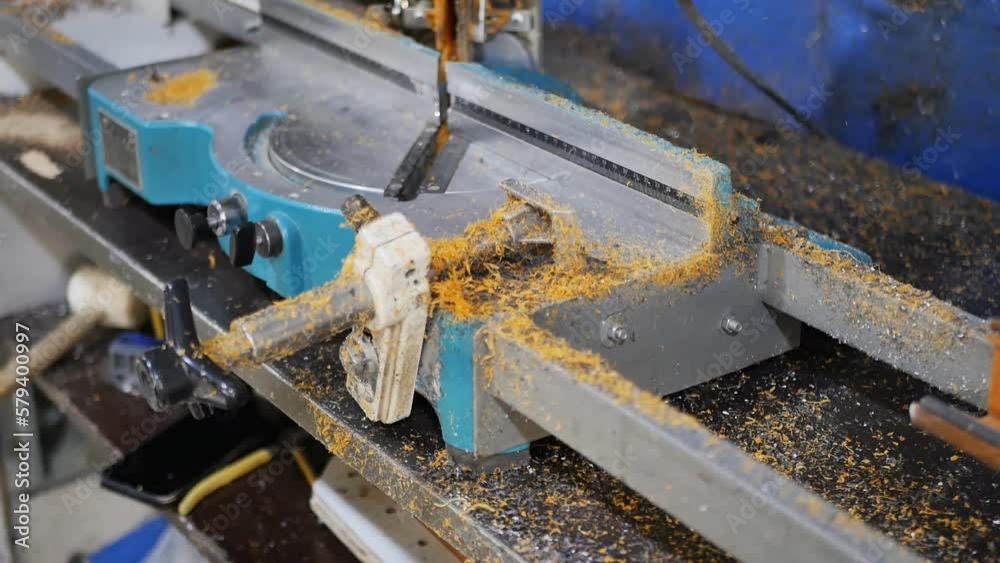 The process of cleaning sawdust and dust from a working machine in production using a jet of compressed air under high pressure, blowing chips onto the floor. Blowing dirt out of a production machine The process of cleaning sawdust and dust from a working machine in production using a jet of compressed air under high pressure, blowing chips onto the floor. Blowing dirt out of a production machine