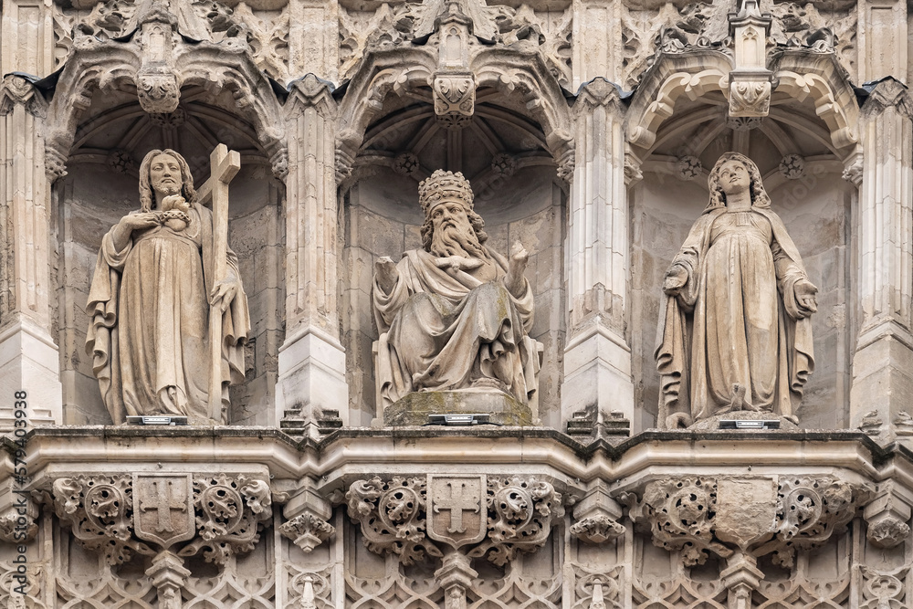 Triptych of ancient statues: God the Father, Jesus Christ, Virgin Mary. Fragment of bell tower of the Saint-Maurice church in Lille sity.