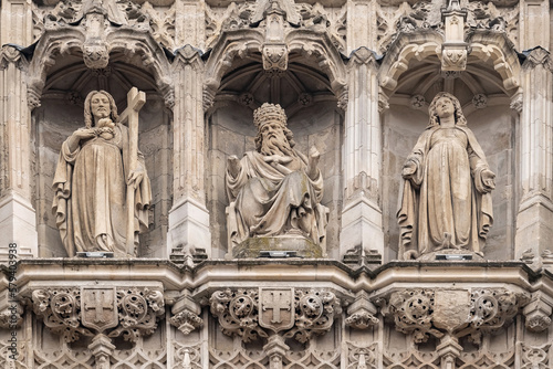 Triptych of ancient statues  God the Father  Jesus Christ  Virgin Mary. Fragment of bell tower of the Saint-Maurice church in Lille sity.