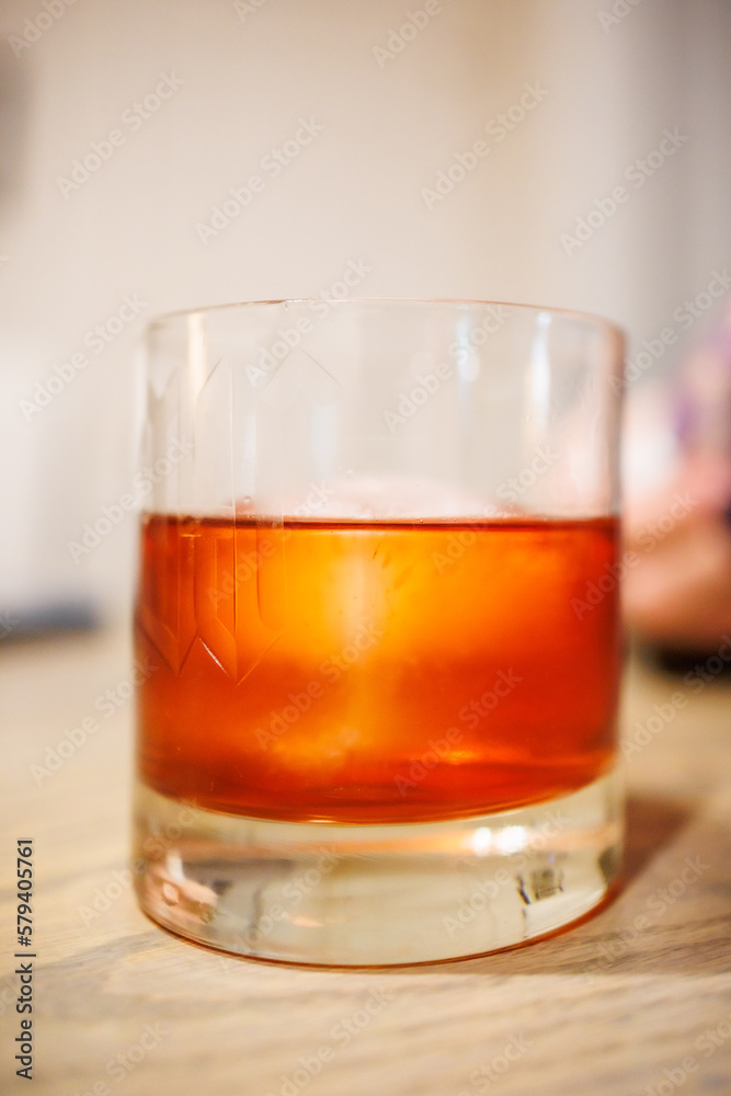 Icey Negroni in glass on table Icey Negroni in glass on table