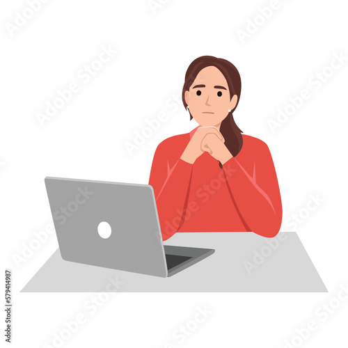 Woman sit and thinking in front of a laptop with her hands on her chin