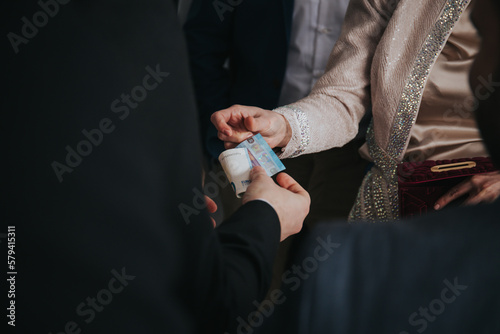 Two people exchaning money - 20 euros