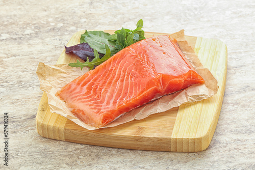 Raw salmon fillet over board