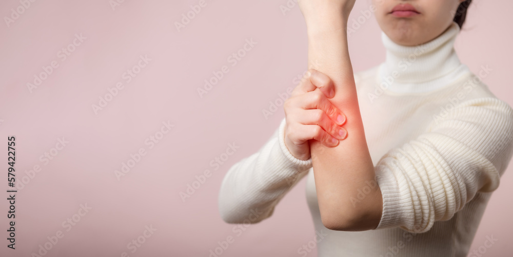 Young asian woman with white sweater cloth suffering from arm pain ...