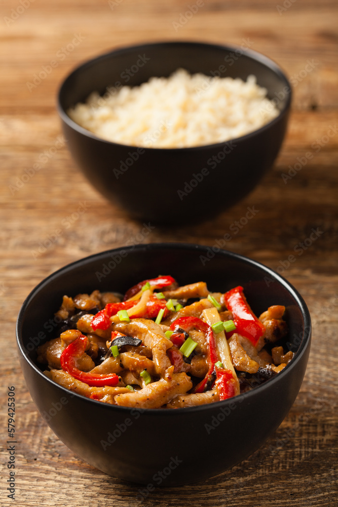 Pork chop with peppers, mushrooms and bamboo. Served with rice. Pork chop with peppers, mushrooms and bamboo. Served with rice.