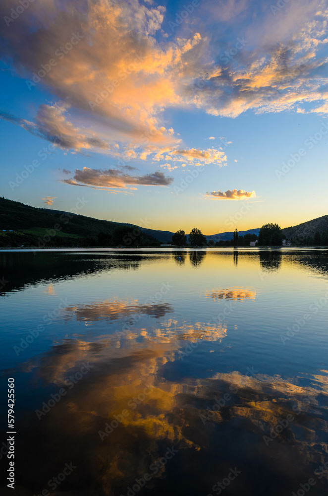 Clouds reflecting off of Nottingham Lake at sunset in Avon, Colorado, USA