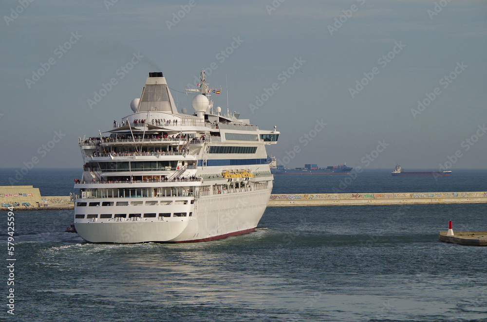 Classic white fun ship cruisehip cruise ship liner Aura sailing away departure from Barcelona, Spain for summer Mediterranean cruising