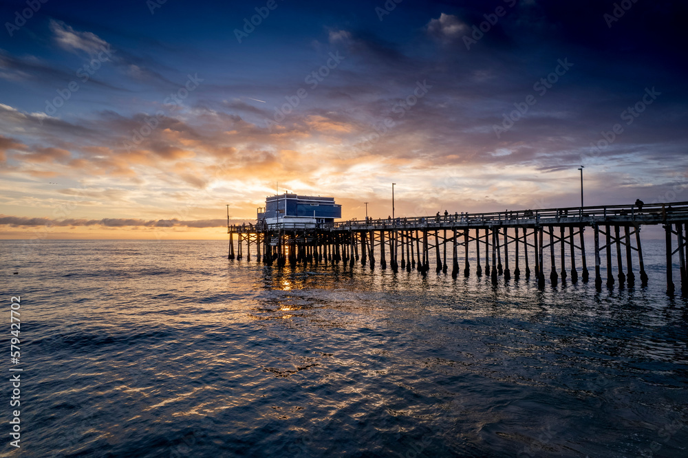 Mesmerizing scene of the pier at Newport Beach under sunset dramatic sky, California