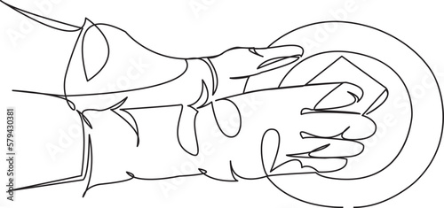 gloved hands washing a plate