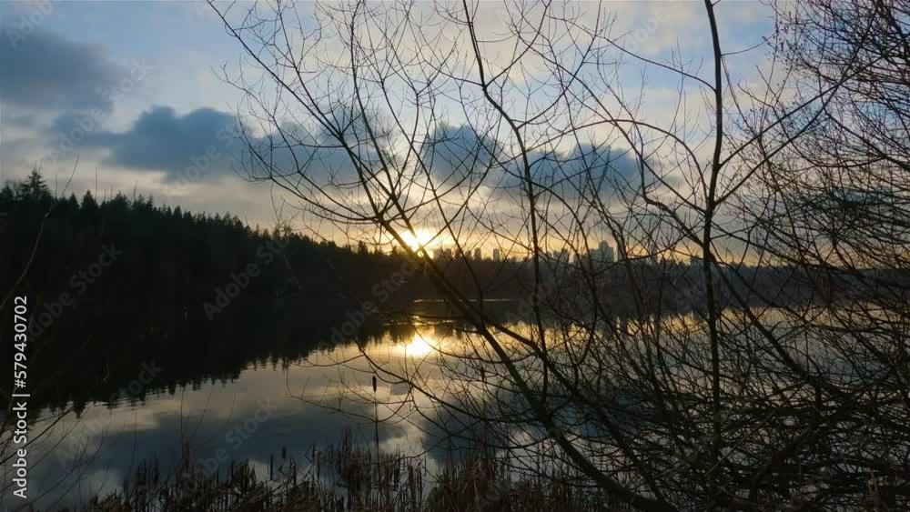 Trail by Peaceful Lake in the modern city, Deer Lake Park. Burnaby, Vancouver, BC, Canada. Colorful Winter Sunset Sky. Slow Motion Cinematic Pan. Trail by Peaceful Lake in the modern city, Deer Lake Park. Burnaby, Vancouver, BC, Canada. Colorful Winter Sunset Sky. Slow Motion Cinematic Pan.