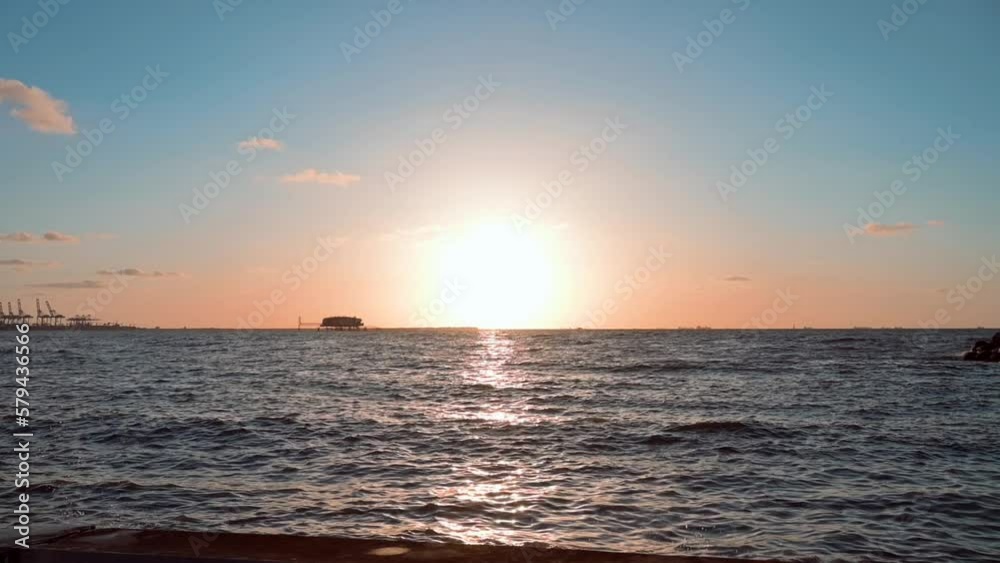Slow motion of the calm Mediterranean Sea with the golden sunset in the background in Alexandria Slow motion of the calm Mediterranean Sea with the golden sunset in the background in Alexandria