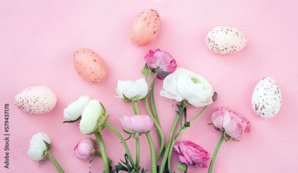 Easter eggs and Buttercups flower bouquet on pastel pink background