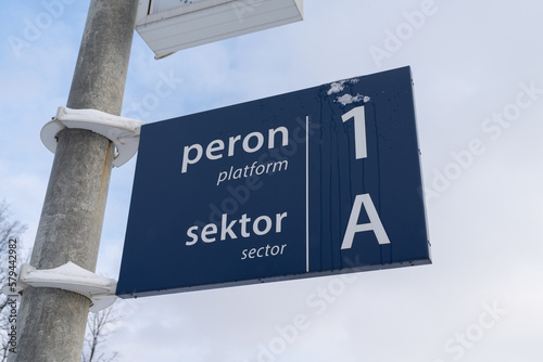 Blue railway station sign in Poland. Train platform number information. Peron in Polish language means platform, sektor means sector.