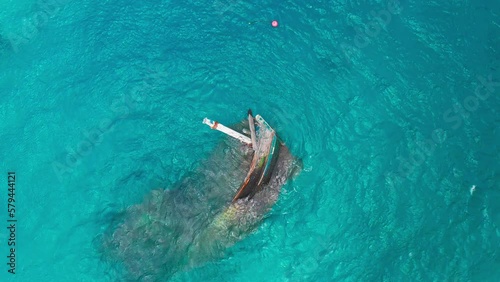 Aerial top view a wreck of a ship sunk in the shallow waters of and now abandoned to bad weather in Keyodhoo, Maldives