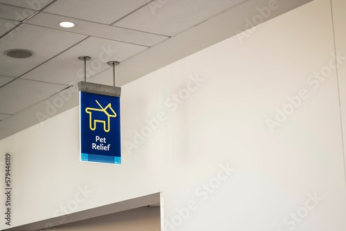 Low angle shot of a blue pet relief sign inside an airport