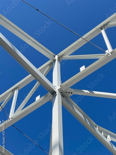 Vertical shot of steel columns and beams on a construction site under a blue sky