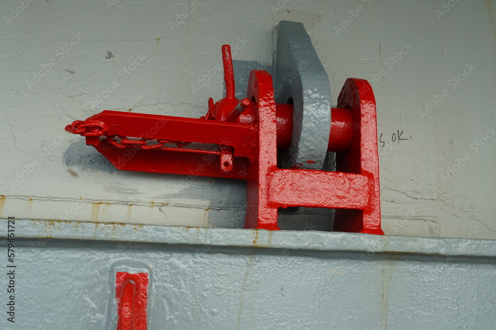 Red jumping stopper or securing cleat with chain used to secure
