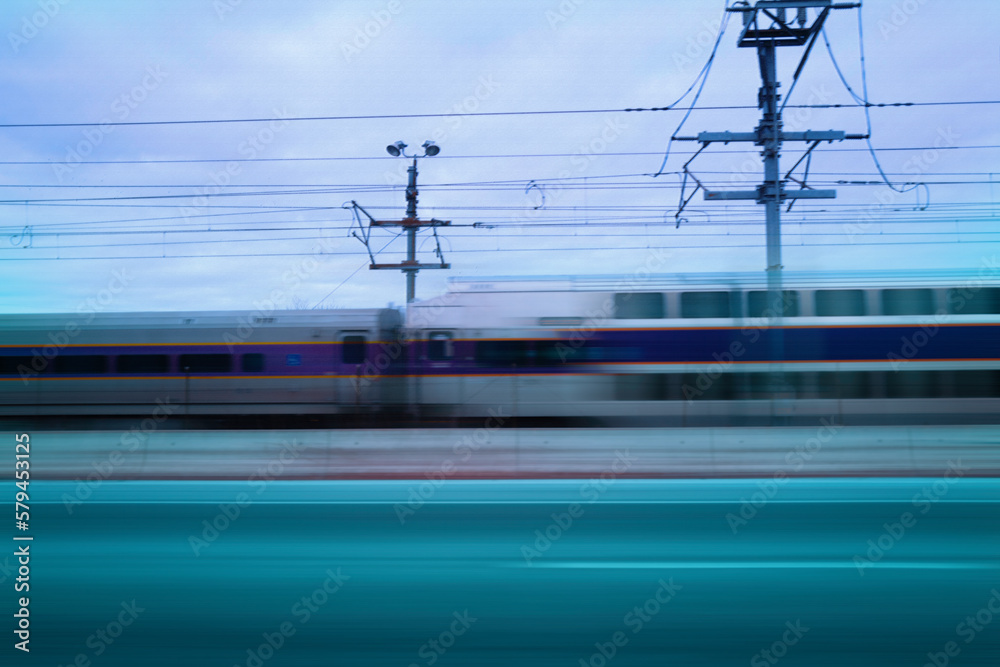 Motion blur commuter train passing on the road, abstract backgrounds for speed, road travel, or direction Motion blur commuter train passing on the road, abstract backgrounds for speed, road travel, or direction