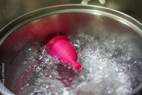 menstrual cup boiling in water. feminine intimate hygiene photo