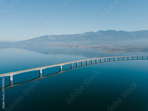 Aerial view of the Lake Polyfytos Bridge with a blue sky in the background  Greece