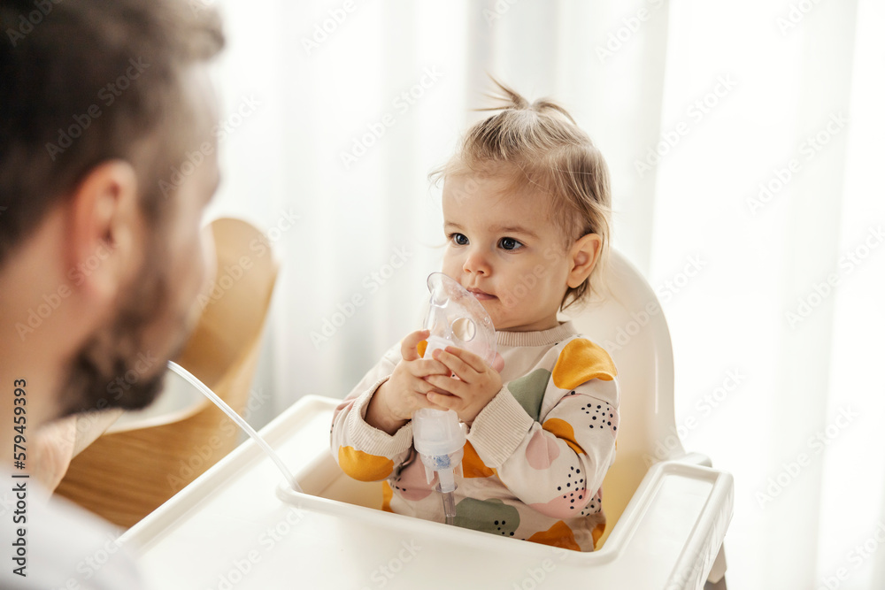 A sick little girl is using inhalator by her own. - obrazy, fototapety, plakaty 