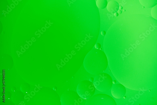 Abstract background with green oil circles on the water.