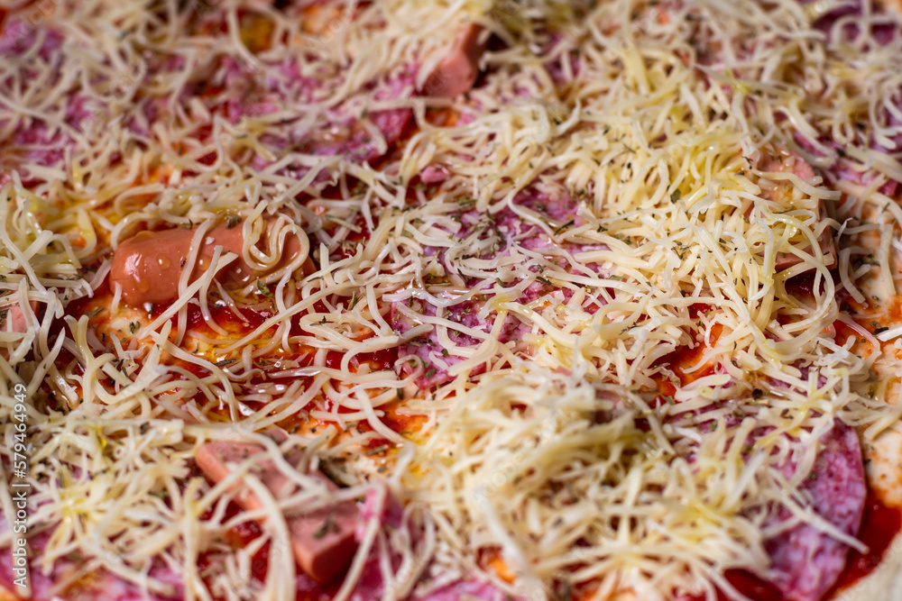 Pizza surface background. Cheese on raw pizza. Food background. Pizza surface background. Cheese on raw pizza. Food background.
