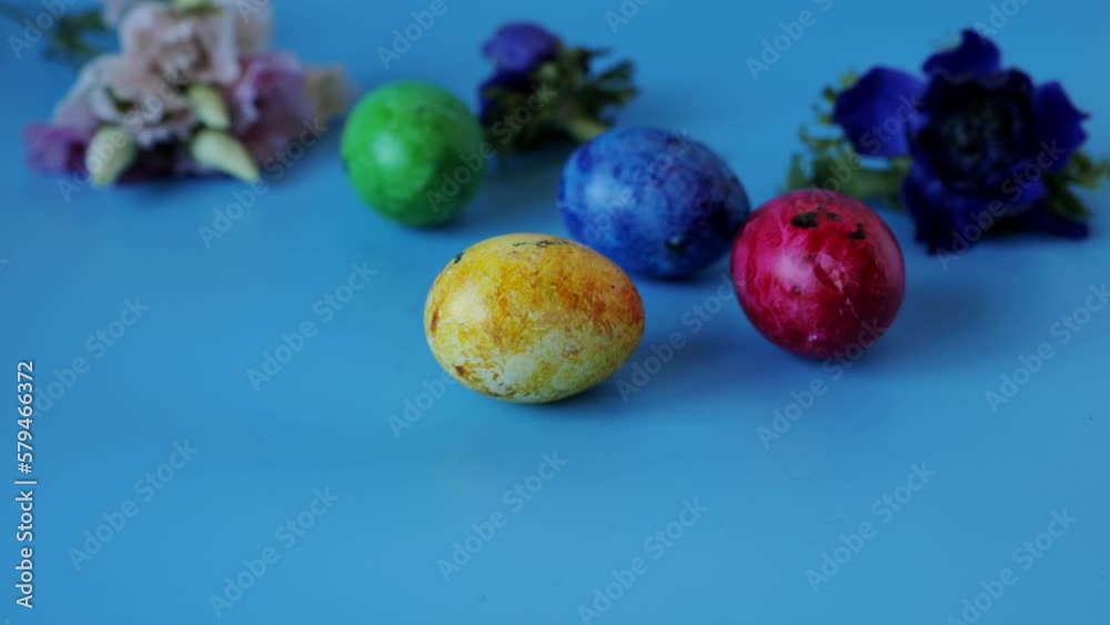 Colourful painted eggs spinning on blue background Colourful painted eggs spinning on blue background