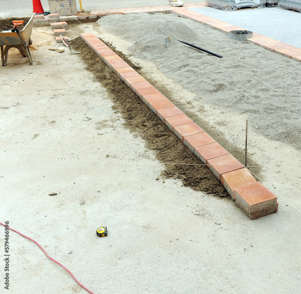 Paving of a new city square built with different materials. Row of ...