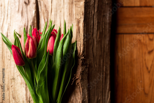 Bouquet of tulips on wooden background. Gift  concept of spring. Mother s Day Greetings.