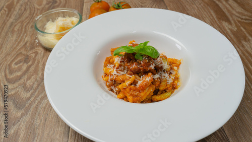 malloreddus or Sardinian gnocchetti, typical Sardinian pasta, with wild boar sauce, basil and pecorino cheese 