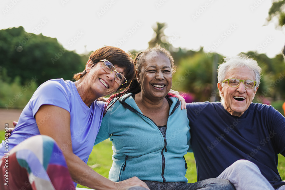 Happy Elderly People Having Fun Hugging Each Other Outdoor After Yoga 