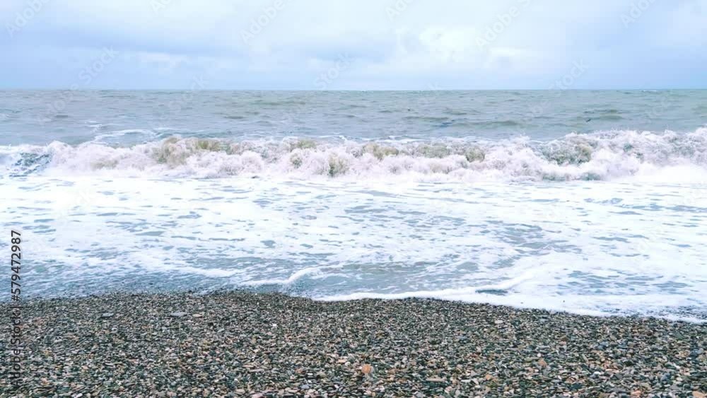Powerful sea waves are crashing on the Black Sea coast. Waves splash on the beach with pebbles during a storm. Storm at sea. Panoramic view of the Black Sea. Russia. Sunset on the beach. 4K Powerful sea waves are crashing on the Black Sea coast. Waves splash on the beach with pebbles during a storm. Storm at sea. Panoramic view of the Black Sea. Russia. Sunset on the beach. 4K