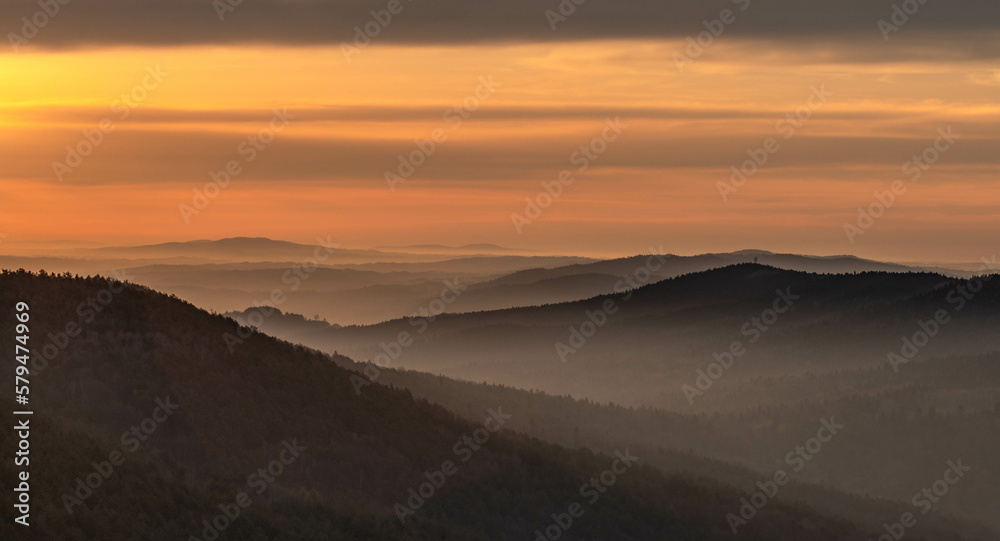 The view of a beautiful landscape at sunrise with amazing light and a mysterious atmosphere.