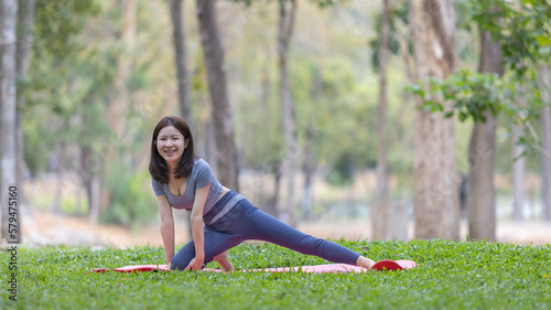 Asian woman doing yoga in nature in the forest, Meditation and breathing exercises, Treat ADHD and train your mind to be calm, Healthy exercise, Mindfulness, Homeopathy, Park yoga.