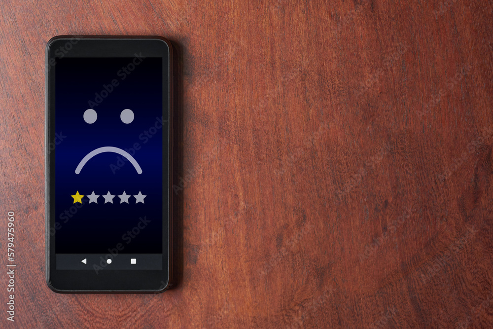 Mobile phone with sad face and