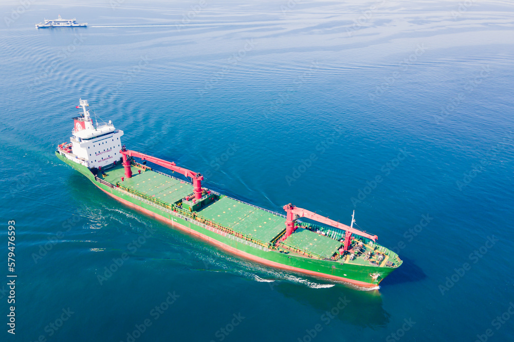 Bulk carrier or bulker is a merchant ship transport unpackaged bulk cargo, grains, ore, coal. Aerial wide shot