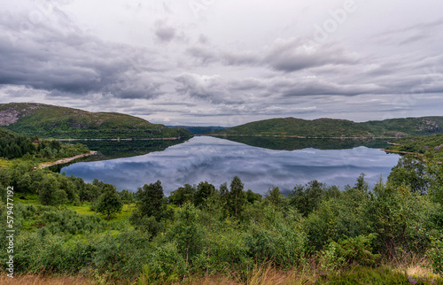 Fototapeta Naklejka Na Ścianę i Meble -  Norway Landscape with Lake and Reflection. Cloudy Blue Sky.