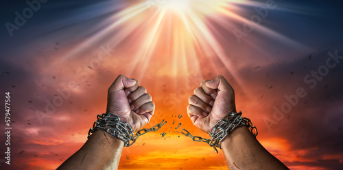 Hands in fists breaking a chain freedom. The concept of gaining freedom.