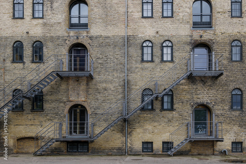 Front exterior view of typical old brick building along waterside of Copenhagen, Denmark. 