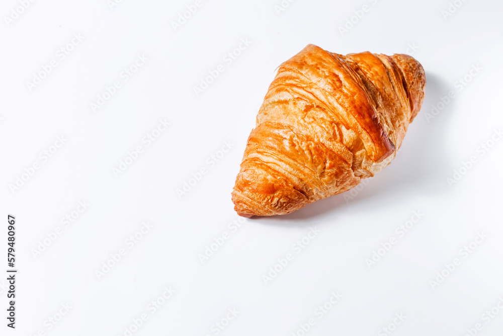 Golden fresh croissant on a white background with space for text Golden fresh croissant on a white background with space for text
