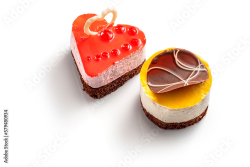 Various cakes with fruit jelly chocolate decoration. Exquisite Fresh delicious mousse dessert on white isolated background with shadow.
