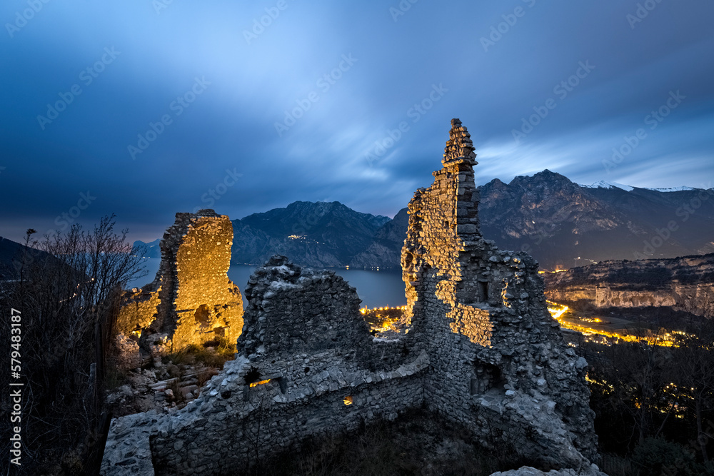 Mysterious night at the medieval ruins of Penede castle. Nago Torbole, Trentino, Italy.