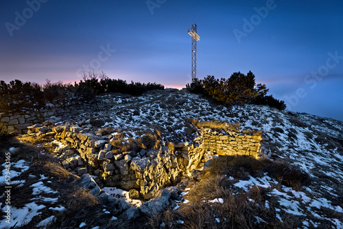 Tableau sur toile Monte Maggio by night: the trenches of the Great War and the large cross on the summit