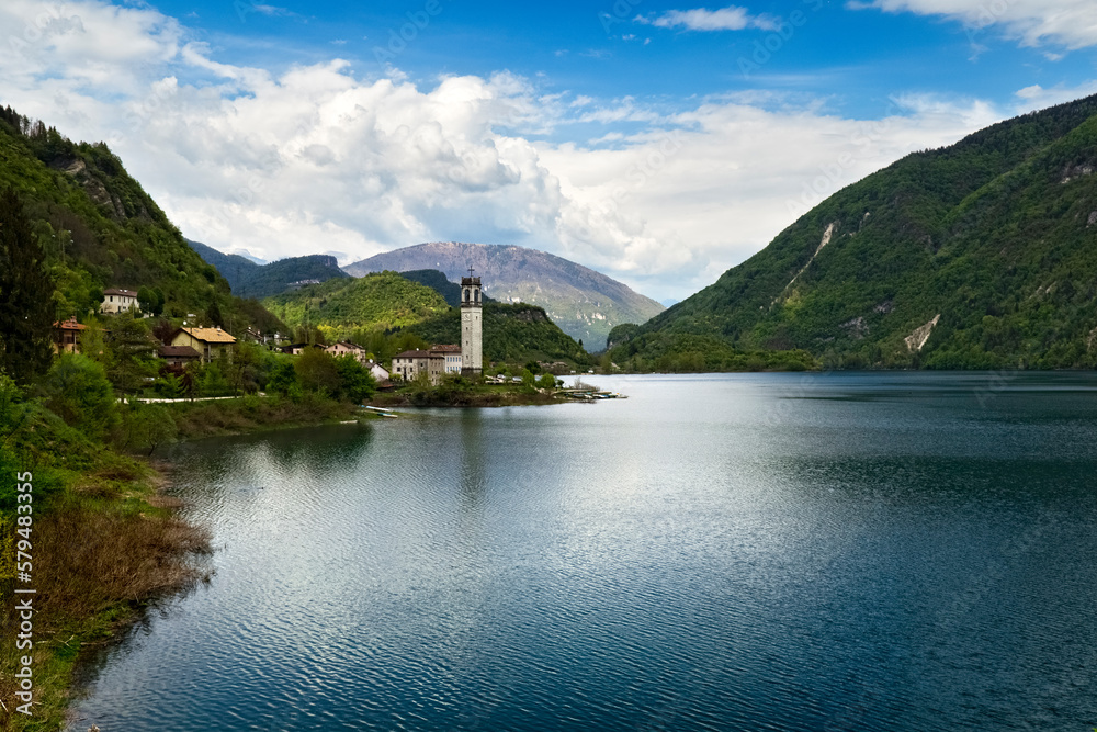 The lake of Corlo and the bell tower of the village of Rocca. Arsié, Belluno province, Veneto, Italy.