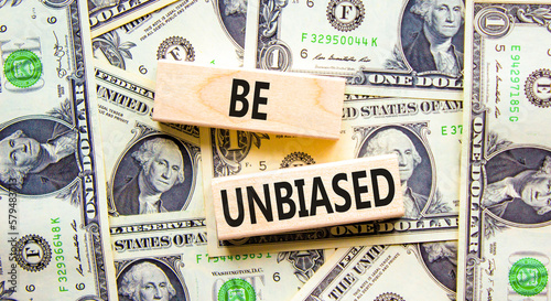 Be unbiased symbol. Concept words Be unbiased on wooden block. Beautiful background from dollar bills. Dollar bills. Business psychology be unbiased concept. Copy space.