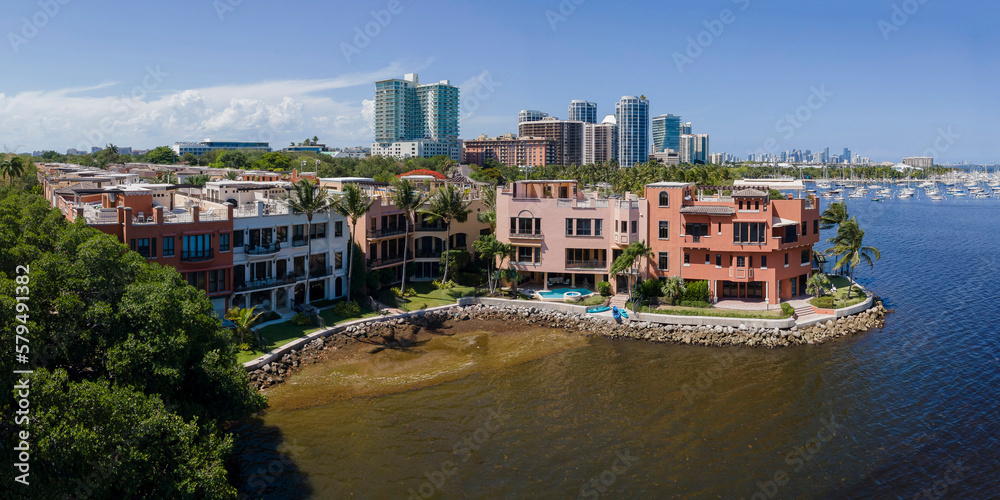 Miami Florida landscape with buildings and skyscrapers along the ocean. Waterfront houses and establishments with scenic view of the sea and blue sky.